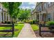 Well-manicured lawns, colorful flowers, and beautiful brick townhomes in community at 2021 Towneship Trl, Roswell, GA 30075