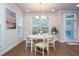 Bright dining area features windows, a hanging light fixture, and hardwood floors at 2021 Towneship Trl, Roswell, GA 30075