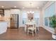 Bright dining area features windows, a hanging light fixture, and stainless appliances at 2021 Towneship Trl, Roswell, GA 30075