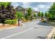 Gated entrance to a well-maintained community with lush landscaping and tree-lined streets at 2021 Towneship Trl, Roswell, GA 30075