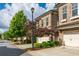 Street view of townhomes with well-manicured lawns and tree-lined street at 2021 Towneship Trl, Roswell, GA 30075