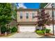 Charming two-story brick townhome with a two-car garage and manicured landscaping in a desirable neighborhood at 2021 Towneship Trl, Roswell, GA 30075