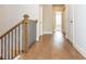 Hallway with hardwood floors, white trim, and multiple doorways at 2021 Towneship Trl, Roswell, GA 30075