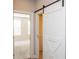 Hallway with barn door and neutral walls leading into a bedroom at 2021 Towneship Trl, Roswell, GA 30075