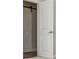 Hallway with barn door and neutral walls leading into another room at 2021 Towneship Trl, Roswell, GA 30075