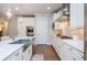 Bright kitchen features stainless steel appliances, white cabinets, and hardwood floors at 2021 Towneship Trl, Roswell, GA 30075