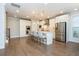 Bright eat-in kitchen features an island with seating, stainless appliances, and beautiful hardwood floors at 2021 Towneship Trl, Roswell, GA 30075