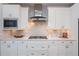 Well-equipped kitchen features stainless steel appliances, white cabinets, and stone countertops at 2021 Towneship Trl, Roswell, GA 30075