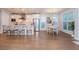 Bright kitchen with stainless steel appliances, a kitchen island, eat-in dining area, and hardwood floors at 2021 Towneship Trl, Roswell, GA 30075