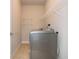 This laundry room features tiled flooring and a newer model washer/dryer at 2021 Towneship Trl, Roswell, GA 30075