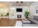 Bright living room with a cozy fireplace, hardwood floors, and natural light at 2021 Towneship Trl, Roswell, GA 30075