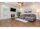 Inviting living room featuring a fireplace, hardwood floors, and comfortable gray sectional sofa at 2021 Towneship Trl, Roswell, GA 30075