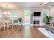 Cozy living room with a fireplace, hardwood floors, and a view of the backyard at 2021 Towneship Trl, Roswell, GA 30075