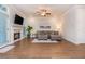 Bright living room features a fireplace, ceiling fan, recessed lighting, hardwood floors, and outside access at 2021 Towneship Trl, Roswell, GA 30075