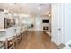 Open concept floor plan with kitchen island seating and living room with fireplace at 2021 Towneship Trl, Roswell, GA 30075
