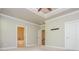 Spacious main bedroom with tray ceiling and doorways to the bathroom and hallway at 2021 Towneship Trl, Roswell, GA 30075