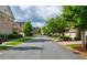 Quiet street view surrounded by lush landscaping and beautiful brick homes at 2021 Towneship Trl, Roswell, GA 30075