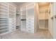 This walk-in closet features custom shelving, drawers, and ample storage space at 2021 Towneship Trl, Roswell, GA 30075