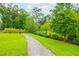 Scenic walking path with lush greenery and well-maintained landscape, perfect for enjoying nature at 2021 Towneship Trl, Roswell, GA 30075