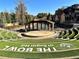 Exterior view of outdoor amphitheater featuring lawn seating and a covered stage for events at Sugar Hill at 338 Sugarview Rd, Sugar Hill, GA 30518