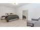 Minimalist bedroom boasts a comfortable bed, a full-length mirror, and a cozy chair with footstool at 338 Sugarview Rd, Sugar Hill, GA 30518