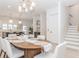 Chic dining area next to gourmet kitchen featuring modern lighting and stairway at 338 Sugarview Rd, Sugar Hill, GA 30518