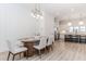 Elegant dining room with modern lighting adjacent to gourmet kitchen, perfect for entertaining guests at 338 Sugarview Rd, Sugar Hill, GA 30518