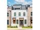 Charming townhome with a white painted brick exterior and a rooftop deck, perfect for city living at 338 Sugarview Rd, Sugar Hill, GA 30518