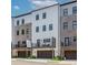Exterior view of new townhomes, each with private balconies and attached garages at 338 Sugarview Rd, Sugar Hill, GA 30518