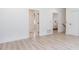 Hallway with luxury vinyl plank flooring, white walls, and multiple doorways providing access to other rooms at 338 Sugarview Rd, Sugar Hill, GA 30518