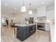 Modern kitchen featuring an island with seating, stainless steel appliances, and pendant lighting at 338 Sugarview Rd, Sugar Hill, GA 30518