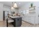 Well-lit kitchen with white cabinets, island seating, stainless appliances, and modern finishes at 338 Sugarview Rd, Sugar Hill, GA 30518