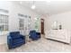 Bright living room with light wood floors, neutral walls, and stylish blue velvet accent chairs at 338 Sugarview Rd, Sugar Hill, GA 30518