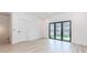 Bright living room with hardwood floors and large sliding doors to an outdoor space at 338 Sugarview Rd, Sugar Hill, GA 30518