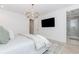Airy main bedroom featuring a TV, chandelier, and spa-like bathroom at 338 Sugarview Rd, Sugar Hill, GA 30518