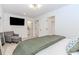 Well-lit main bedroom with ensuite bathroom, walk-in closet, and a comfortable seating area at 338 Sugarview Rd, Sugar Hill, GA 30518