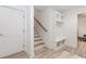 Bright mud room featuring built-in storage, coat hooks, and seating bench, complemented by a staircase at 338 Sugarview Rd, Sugar Hill, GA 30518