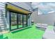 Outdoor patio space with modern furniture, sliding doors, and artificial turf at 338 Sugarview Rd, Sugar Hill, GA 30518