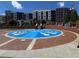 Community splash park featuring a vibrant blue design with white accents and brick borders near apartments at 338 Sugarview Rd, Sugar Hill, GA 30518