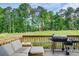 A cozy back deck featuring outdoor seating and a grill, perfect for enjoying the natural scenery at 3622 Utoy Dr, South Fulton, GA 30331