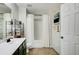 Bright bathroom featuring a shower with white curtains, a sink, storage shelves and green cabinets at 3622 Utoy Dr, South Fulton, GA 30331