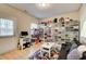 A multi purpose room with a door to the exterior, storage racks, and relaxing sofa at 3622 Utoy Dr, South Fulton, GA 30331
