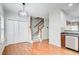 Hallway with storage closet leading to a carpeted staircase and a view of the kitchen at 3622 Utoy Dr, South Fulton, GA 30331