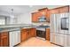 Well-lit kitchen with stainless steel appliances, wooden cabinets, and stone countertops at 3622 Utoy Dr, South Fulton, GA 30331