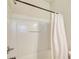 Clean white shower and tub with modern fixtures and shower curtain at 3622 Utoy Dr, South Fulton, GA 30331