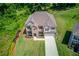 Aerial view of a well-maintained home with a large yard, mature trees, and a long driveway at 4931 Pauls Pointe, Sugar Hill, GA 30518