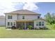 Expansive backyard with a screened porch, lush lawn, and mature landscaping, perfect for outdoor living at 4931 Pauls Pointe, Sugar Hill, GA 30518
