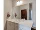 Bathroom with a white vanity, large mirror, and white cabinets at 4931 Pauls Pointe, Sugar Hill, GA 30518