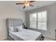 Comfortable bedroom features a queen-size bed, ceiling fan, and a window at 4931 Pauls Pointe, Sugar Hill, GA 30518