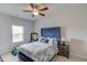 Well-lit bedroom with ceiling fan, plush bedding, and a comfortable modern design at 4931 Pauls Pointe, Sugar Hill, GA 30518